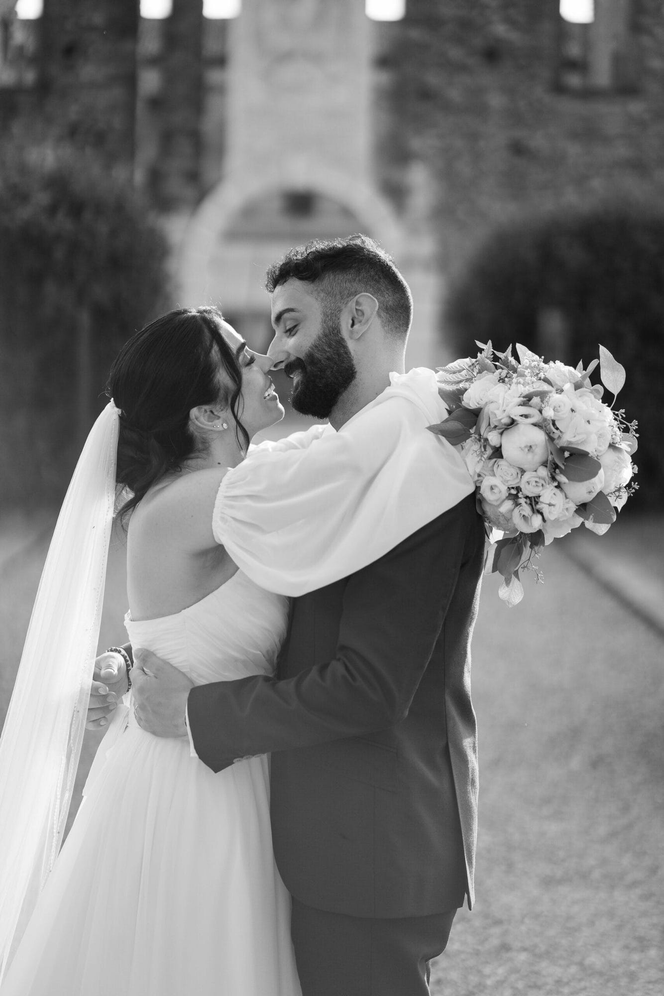 Un dolce abbraccio degli sposi in un angolo suggestivo del Castello di Cavernago, durante il loro matrimonio testimoni di Geova a Bergamo